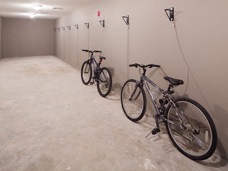 bike storage room with two bikes chained to the wall security system